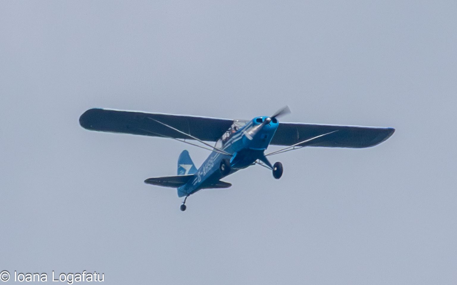 Vintage airplane soaring through cloudy skies